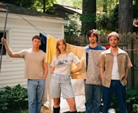 a group of people standing in front of a clothesline