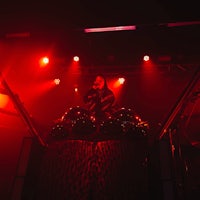 a man on a stage with red lights