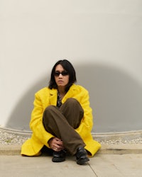 a woman wearing a yellow jacket