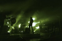 a group of people on stage with green lights