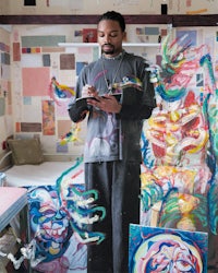 a man standing in front of a painting