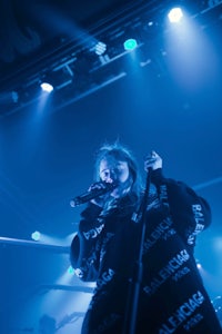 a woman singing into a microphone at a concert