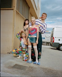 a group of people posing in front of a building