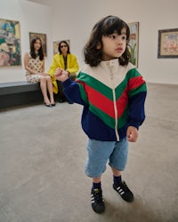 a little girl standing in an art gallery