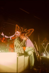 a man on stage with a butterfly on his head