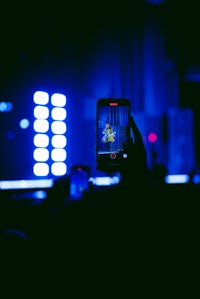 a person taking a photo of a concert