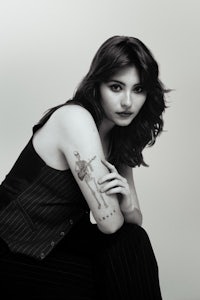 a black and white photo of a woman with a tattoo