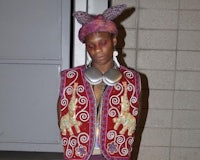 a woman wearing a colorful vest and headphones