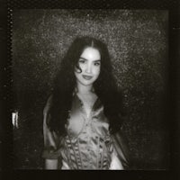 a woman is posing for a photo in a black and white polaroid