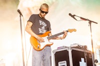 a man playing an electric guitar at a concert