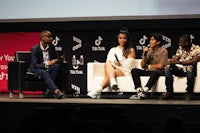 a group of people sitting on chairs at an event