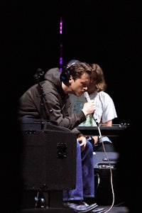 a man is sitting in front of a microphone