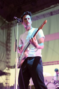 a man playing a guitar on stage