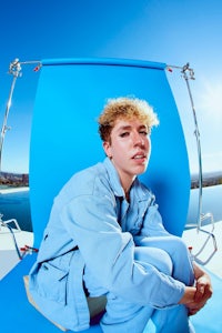 a person sitting on a blue chair