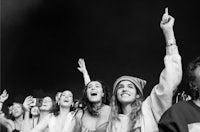 a group of people cheering at a music festival