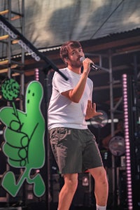 a man singing into a microphone at a concert