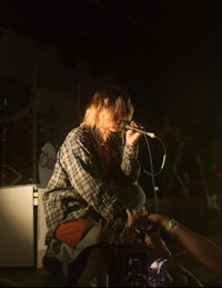 a woman on stage with a microphone in her hand