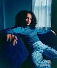 a young woman sitting on a blue couch