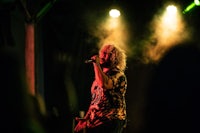 a man singing into a microphone at a concert