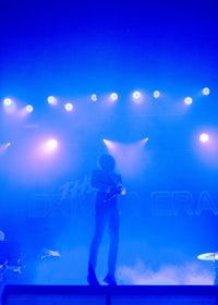 a man standing on a stage with blue lights