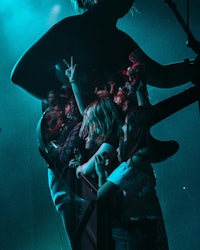 a man playing a guitar in front of a crowd