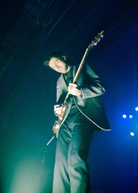 a man playing a guitar on stage