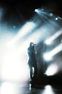 a person standing on stage with a microphone