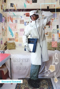 a man in a white coat standing in a room