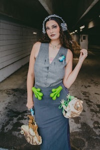 a woman dressed as a frog wearing a skirt and hat