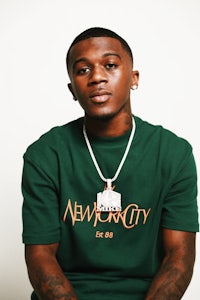 a man wearing a green t - shirt with the word new city on it