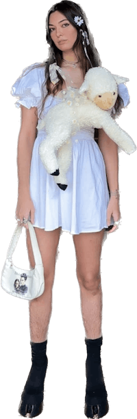 a woman in a white dress holding a stuffed animal