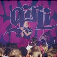 a girl is singing on stage in front of a crowd