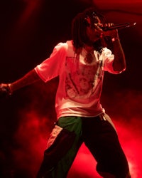 lil wayne performs on stage with dreadlocks