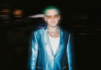 a man in a suit with green hair