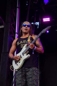 a man playing a guitar on stage