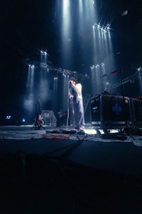 a man standing on stage with a microphone