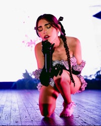 a woman crouching down on a stage