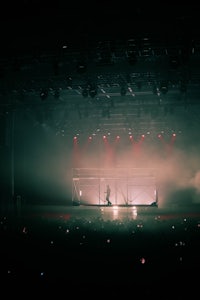 a person standing on stage in a dark room