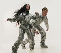 a man and woman dressed in silver outfits