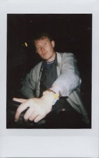 polaroid of a man sitting in a car