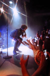 a crowd of people watching a band perform