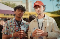 two men standing next to each other at an outdoor event