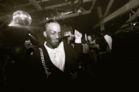 a black and white photo of a man at a party