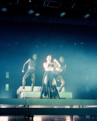 a group of people on stage in a dark room