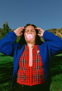 a woman blowing bubbles in a park