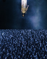 a man floating in the air in front of a crowd