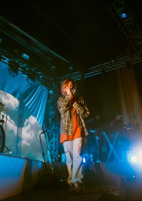 a man standing on stage with a microphone