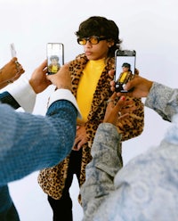 a group of people taking selfies in a leopard coat