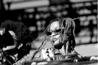 two djs with dreadlocks standing next to each other