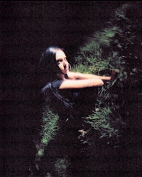 an image of a woman laying in the grass